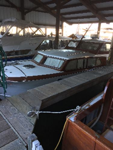 35’ classic wood hull cabin cruiser in slip