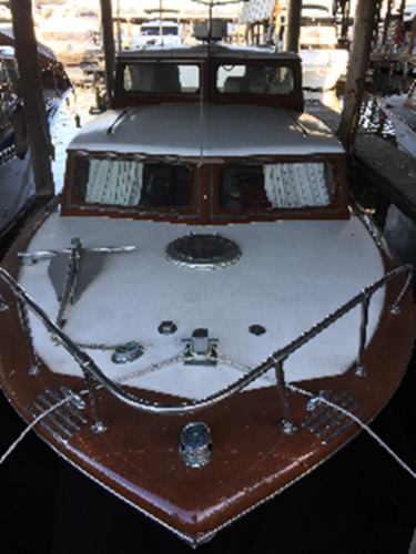 35’ classic wood hull cabin cruiser on the bow